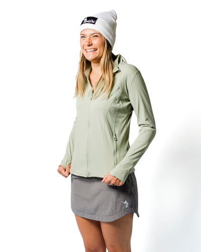 Load image into Gallery viewer, Woman wearing a light green jacket and gray skirt on a white background